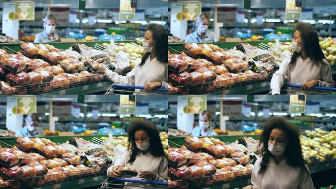 戴口罩的妇女在水果区购物