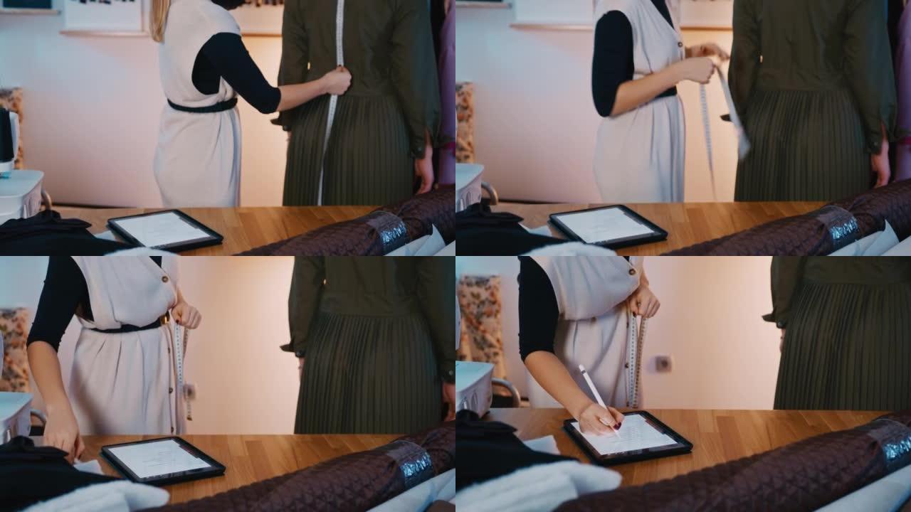 SLO MO女裁缝使用数字平板电脑写下客户的尺寸