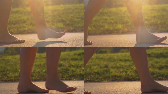 特写，低角度: 年轻的女士在美丽的光线下赤脚走在沥青上