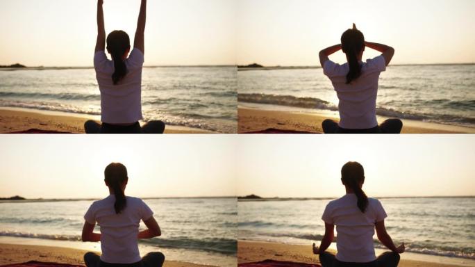 沙滩上的剪影瑜伽女人，健康的生活方式