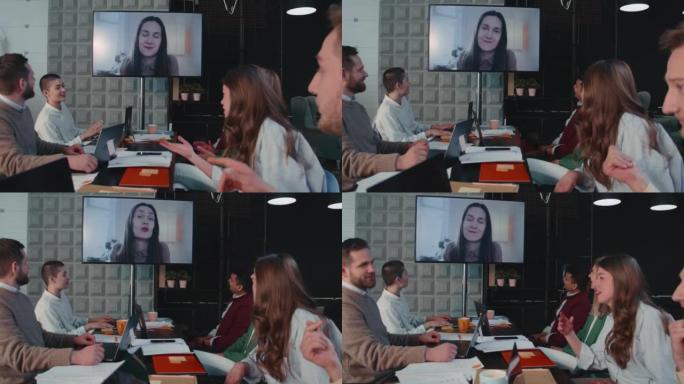 商务团队在办公室会议慢动作时使用视频通话和投影仪与女老板交谈。