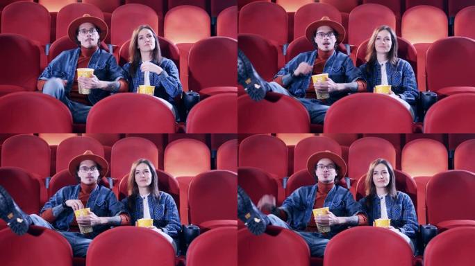男孩和女孩在电影院看电影。看电影，花时间的概念。