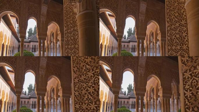 摄像机在墙壁和柱子之间移动，带有摩尔式建筑的狮子法院，阿罕布拉，格拉纳达，安达卢西亚，西班牙，欧洲。