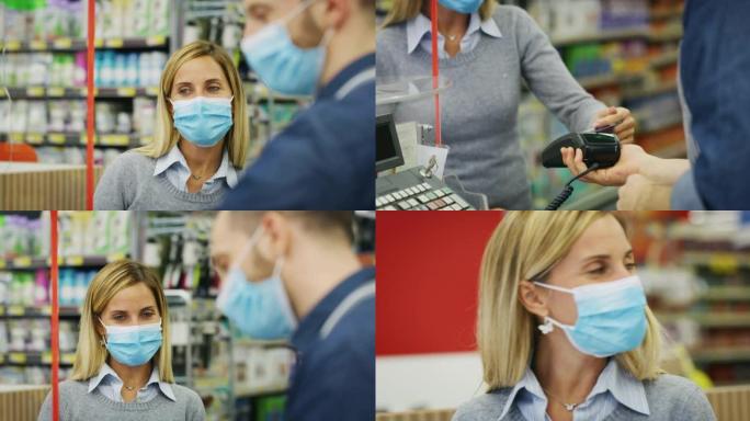 真实拍摄的女顾客和男收银员戴着医用口罩，以保护自己免受疾病，在超市用信用卡支付食品杂货。