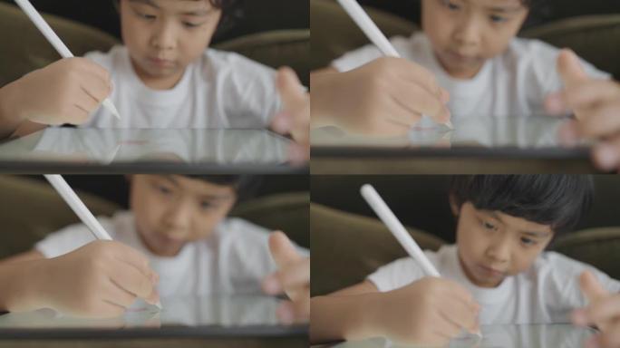 亚洲男孩数字艺术家在图形平板电脑上绘画。