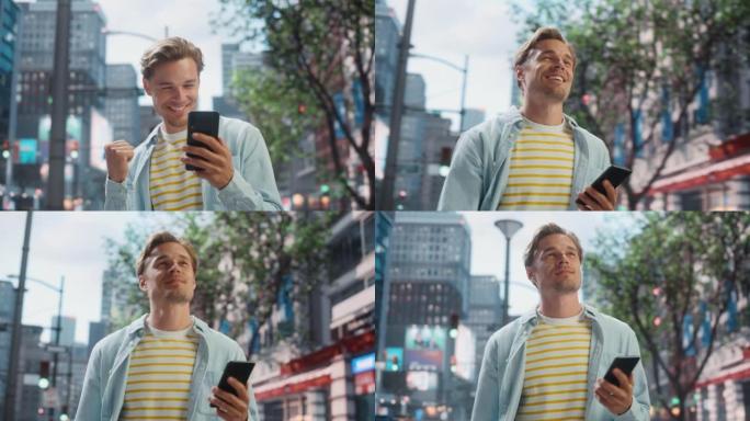 一个英俊的年轻人穿着便服，在城市街道上使用智能手机的肖像。成功的男性在电话里得到好消息。在大城市为胜