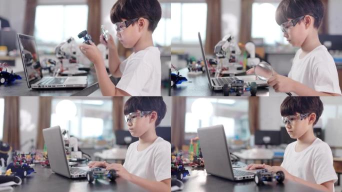 一个小学生在笔记本电脑上编程机器人