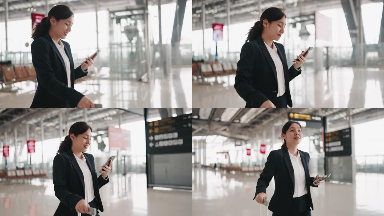 女商人在机场使用智能手机时走路