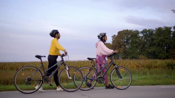 慢动作，追踪两名成年女性在高速公路上骑自行车，享受休闲活动的镜头