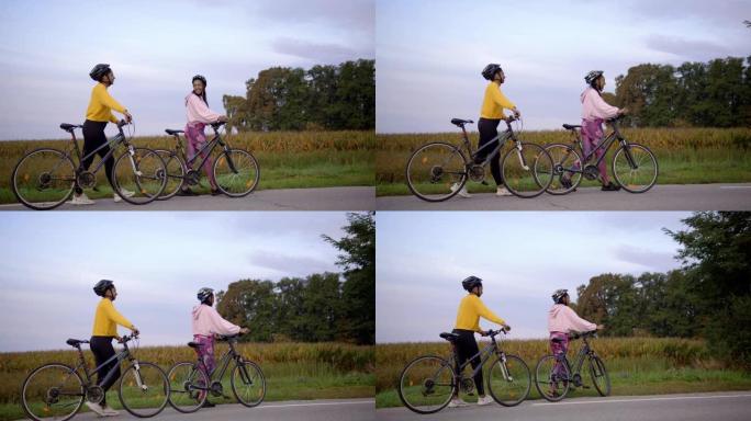 慢动作，追踪两名成年女性在高速公路上骑自行车，享受休闲活动的镜头