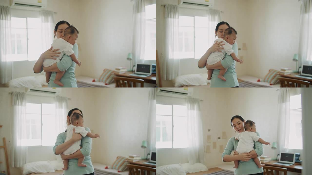 亚洲妈妈抱着她可爱的宝宝
