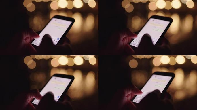 CU女人晚上在黑暗的海滩上用智能手机发短信
