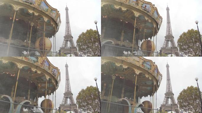 旋转木马和埃菲尔铁塔的低角度视图，埃菲尔铁塔是世界著名的锻铁格子塔，是法国巴黎最著名的地标。慢动作。