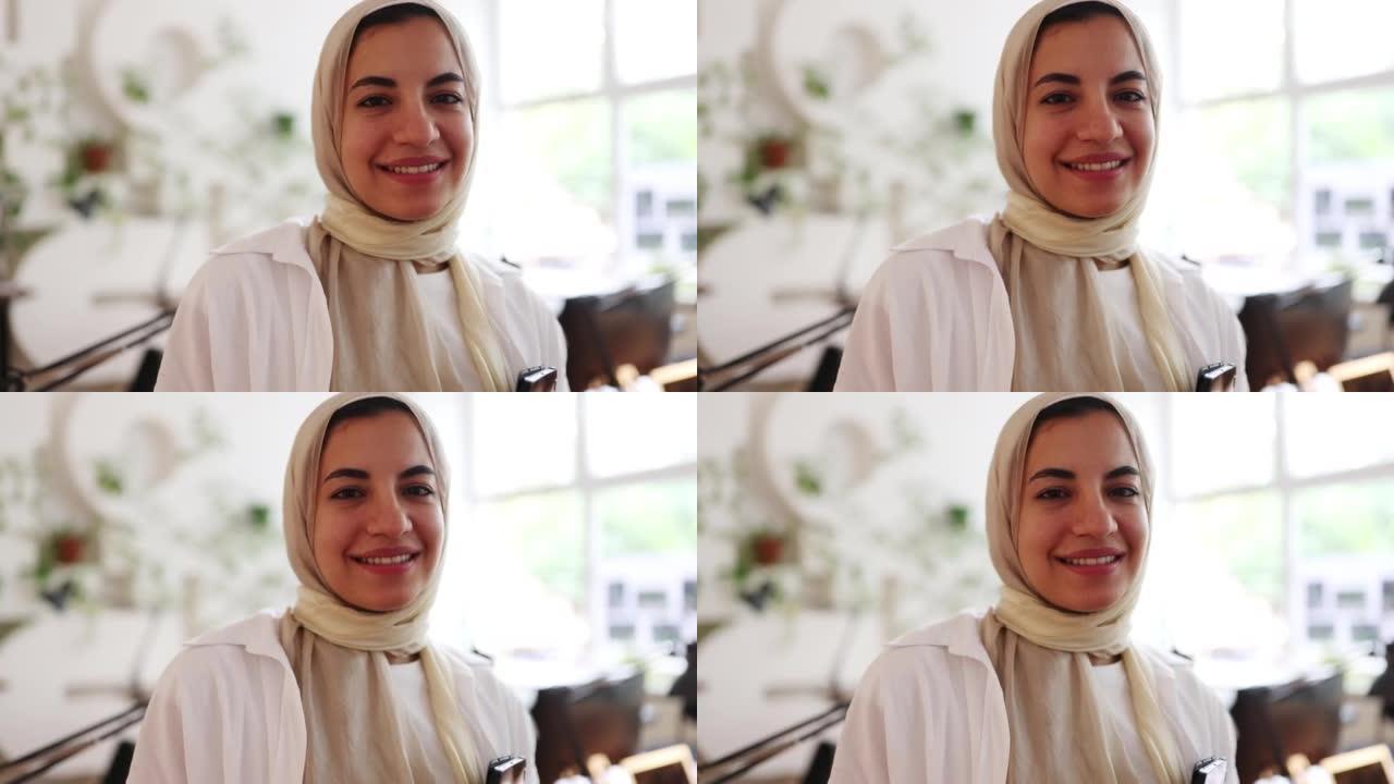 戴着头巾的快乐年轻穆斯林女商人的特写肖像