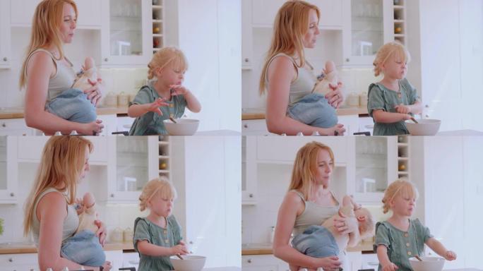 女孩在厨房柜台吃早餐看手机，而母亲抱着婴儿