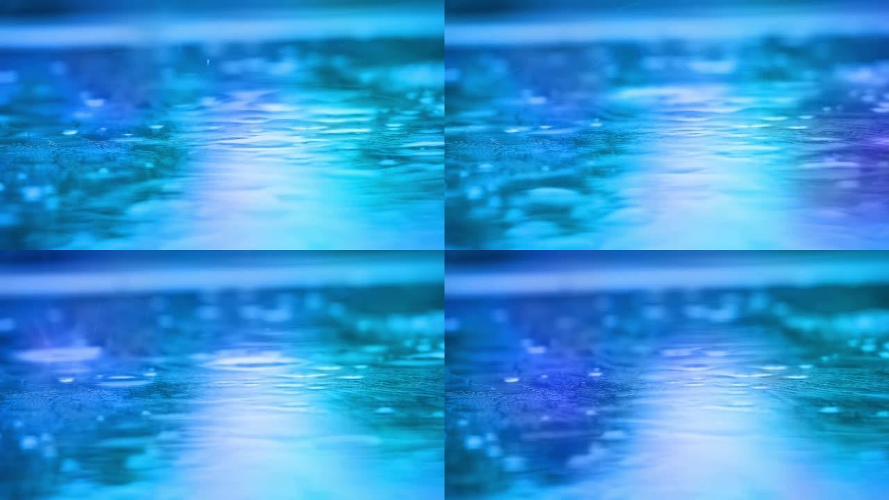 霓虹灯城市颜色反映在玻璃表面的雨水中