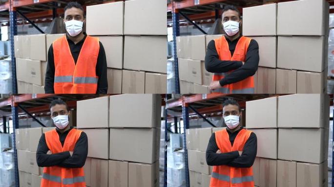 工人戴着口罩站在仓库里