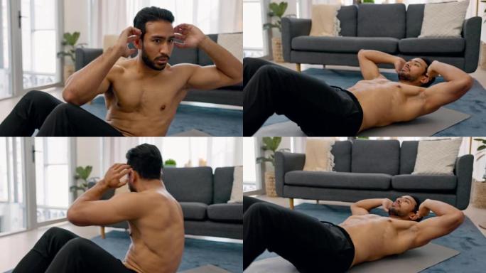 锻炼，锻炼和健身和一个男人做仰卧起坐在他的家的客厅，以健康和健康。一个在房子里锻炼身体的男运动员的激