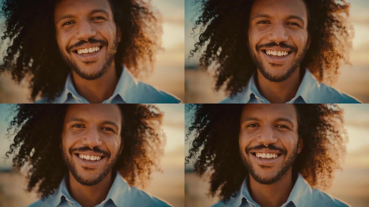 特写一位快乐的年轻成年男性的肖像，他的头发是非洲的，鼻环刺穿了镜头。英俊多样的多种族黑人男性微笑。暖