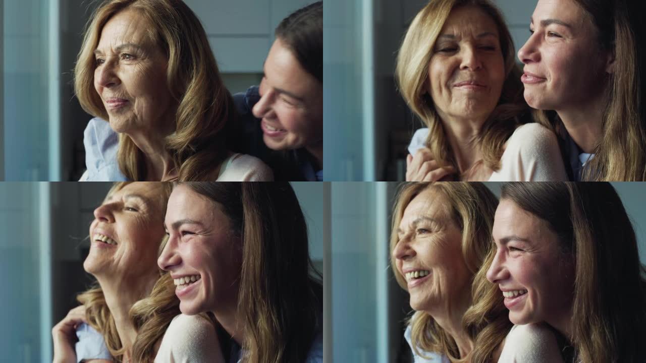 电影拍摄的快乐孙女给祖母以情感的拥抱，以示爱与尊重，同时透过窗户看家里。概念: 生活，祖父母，世代，