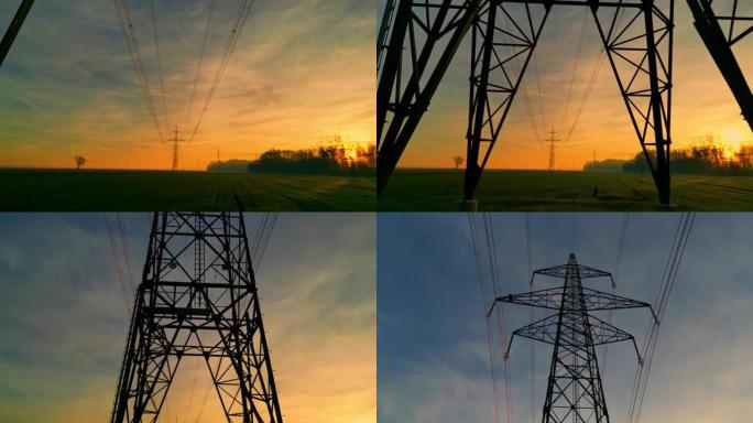 日落时田园诗般的乡村上的电塔和电线