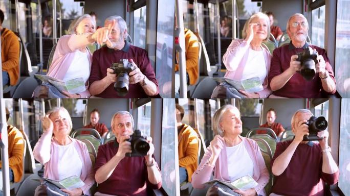 高级夫妇在公共汽车内观光和拍照