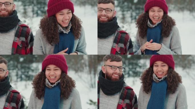 快乐的多民族有趣的年轻朋友微笑，一起笑着穿着温暖的冬装在白雪皑皑的森林慢动作。
