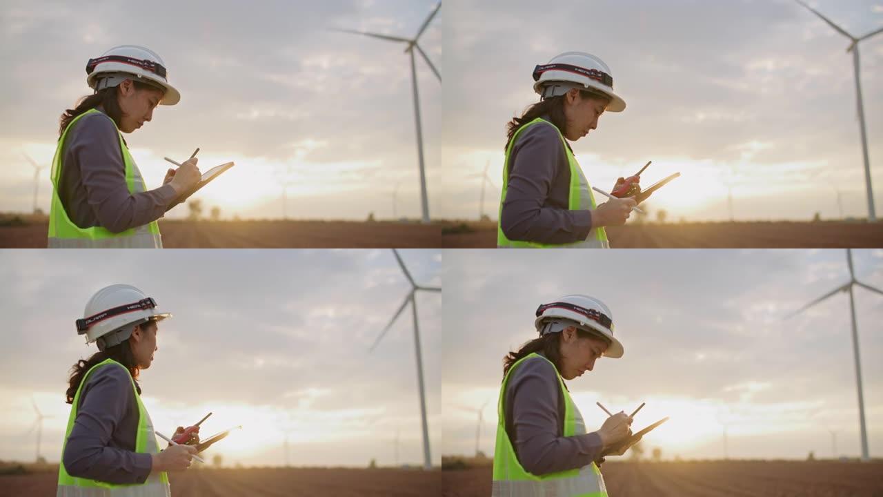 戴安全帽对抗风力发电机的女工程师