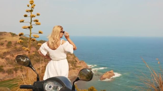意大利撒丁岛海岸边一个戴着墨镜的金发女人的景色。