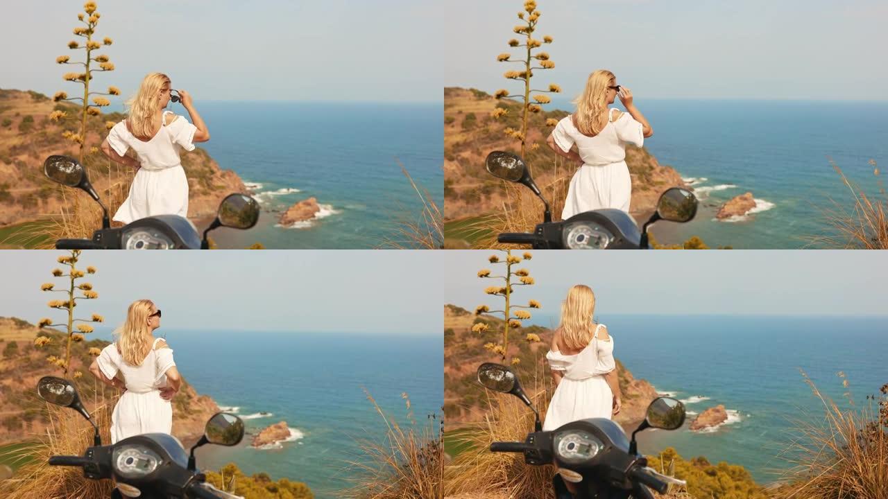 意大利撒丁岛海岸边一个戴着墨镜的金发女人的景色。