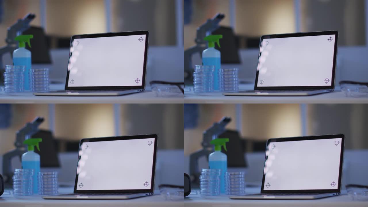 在空实验室的工作站上带照明屏幕的笔记本电脑