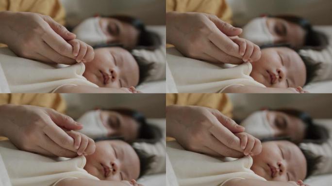 母亲和新生儿用防护面罩睡觉