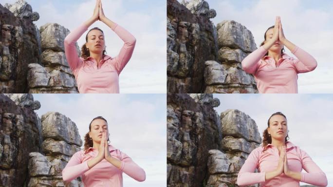 白人妇女在乡村山腰环境中户外练习瑜伽冥想