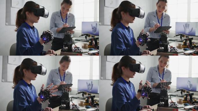 工程师使用VR眼镜控制机器人手臂在实验室安装