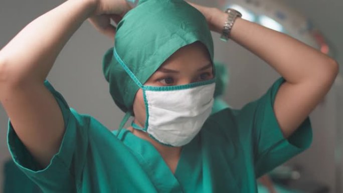 亚洲女外科医生在手术中戴上医用口罩，外科医生准备手术