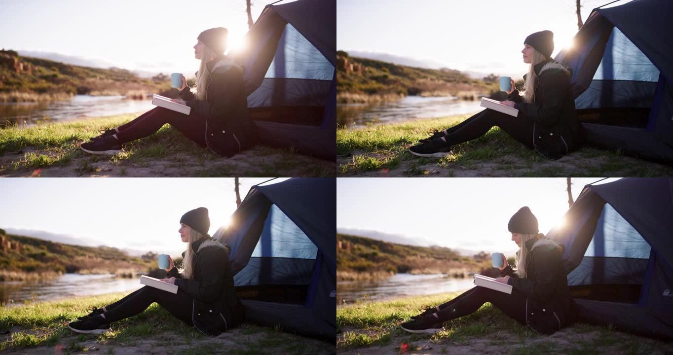4k视频片段，一名年轻女子在露营旅行中坐着喝咖啡和阅读