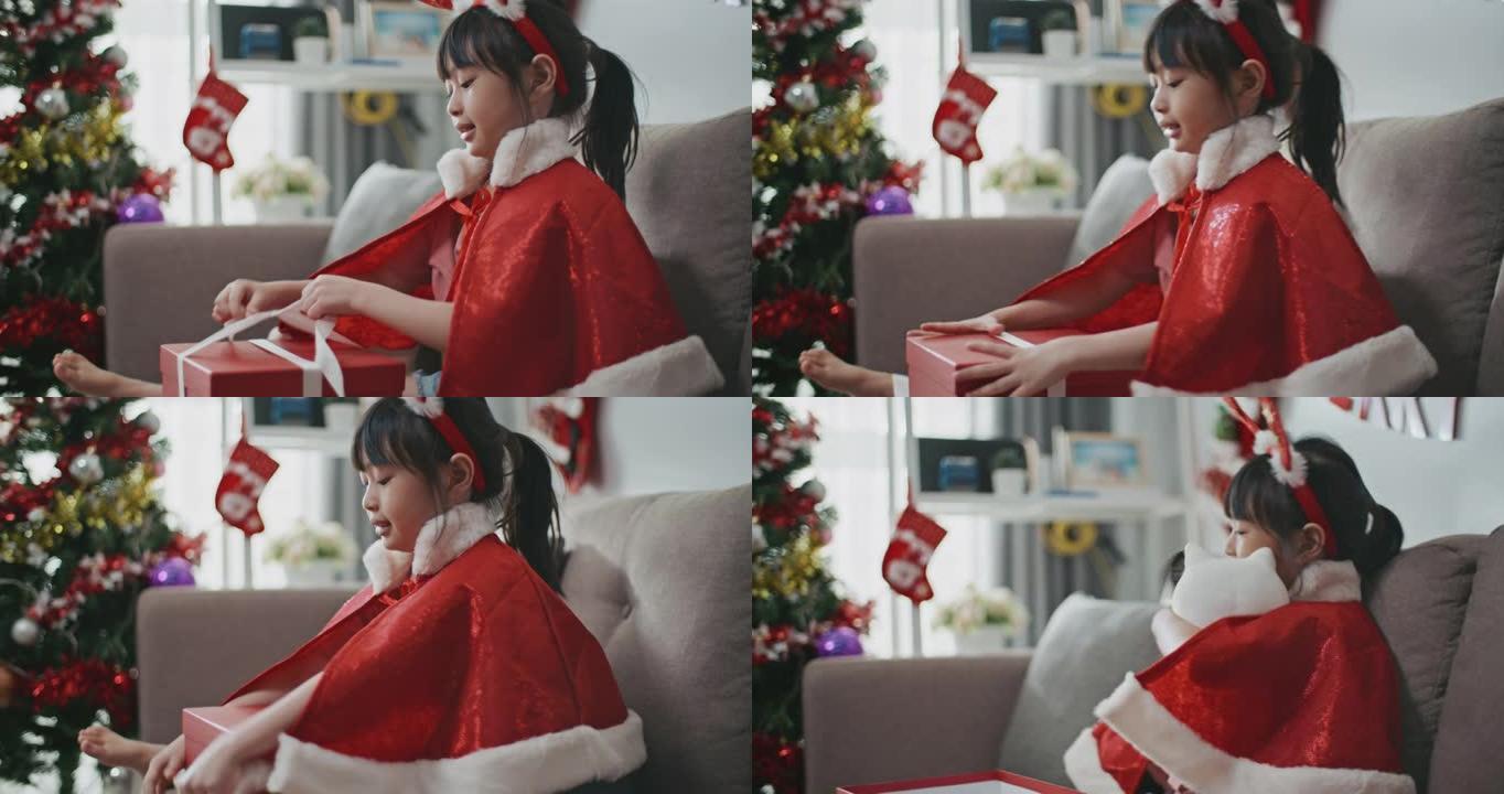 亚洲女孩在圣诞节打开礼品盒