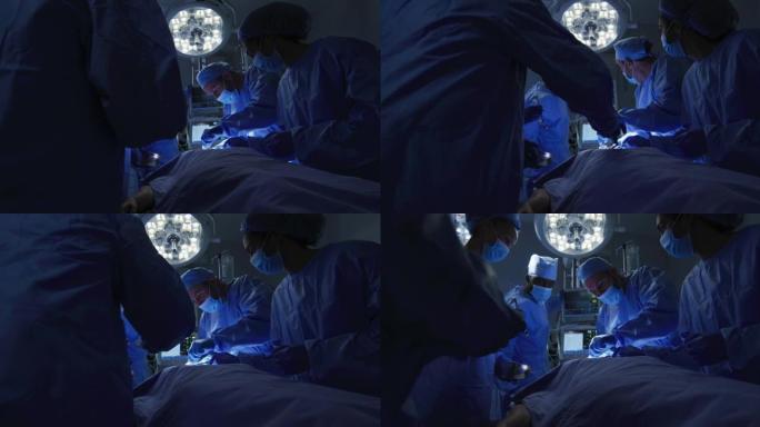 混血外科医生穿着防护服在手术室进行手术