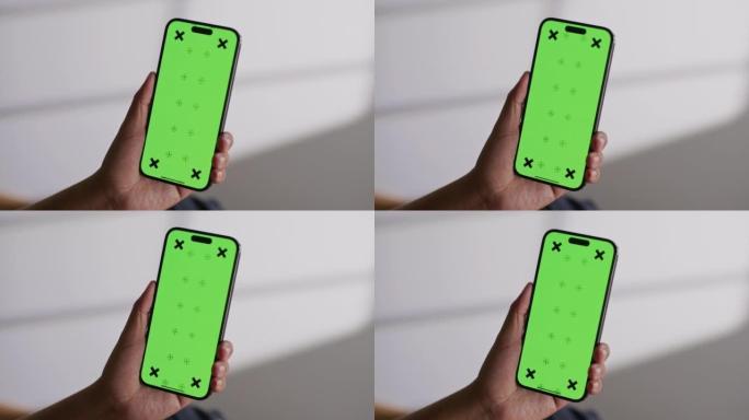 男人在手机绿屏上使用app
