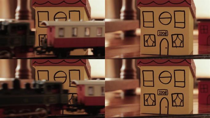 蒸汽机车模型火车和纸板玩具屋。特写。