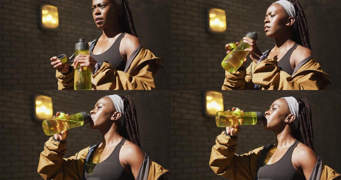 非裔美国妇女在城市户外锻炼饮用水