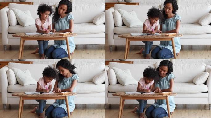 年轻的黑人妈妈向学龄前女儿解释数学基础