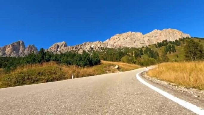 在美丽的晴天，驾驶汽车在山路上穿越充满活力的风景如画，第一人称视角