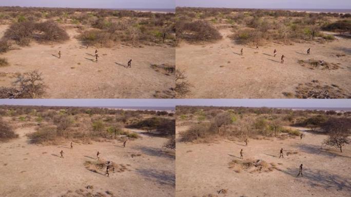 空中。由于气候变化，哈扎 (Hadza) 狩猎采集者部落成员在干旱的景观中用弓箭狩猎。坦桑尼亚