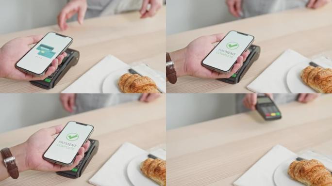 女人在咖啡店中使用NFC技术通过智能手机付款