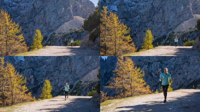 身体意识强的女人保持健康的生活方式，在山间小径上奔跑，风景令人难以置信