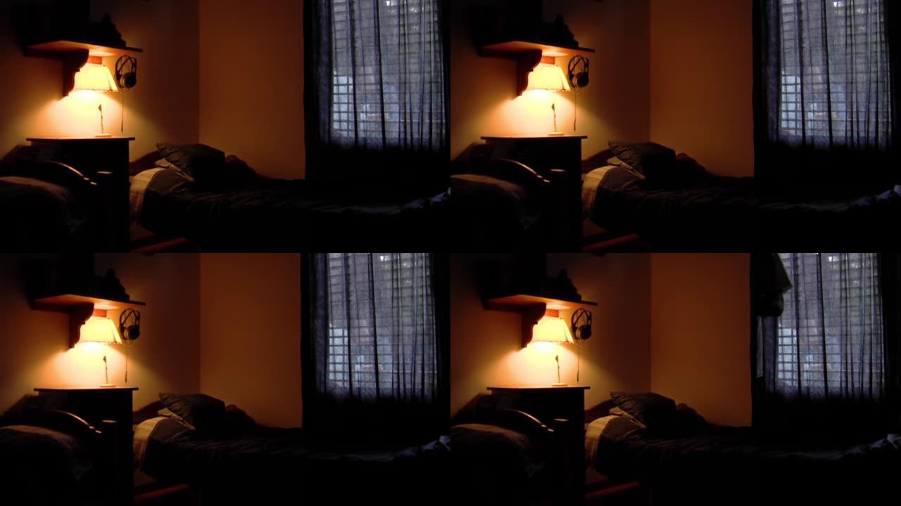 床旁床头柜上的灯在房间里散布着昏暗的黄光。