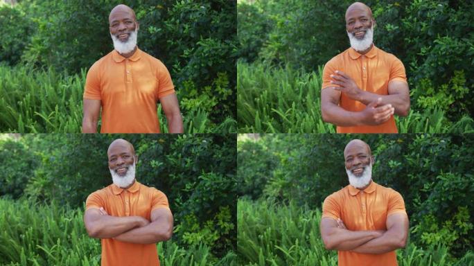 非裔美国老人在花园里微笑和双臂交叉的肖像