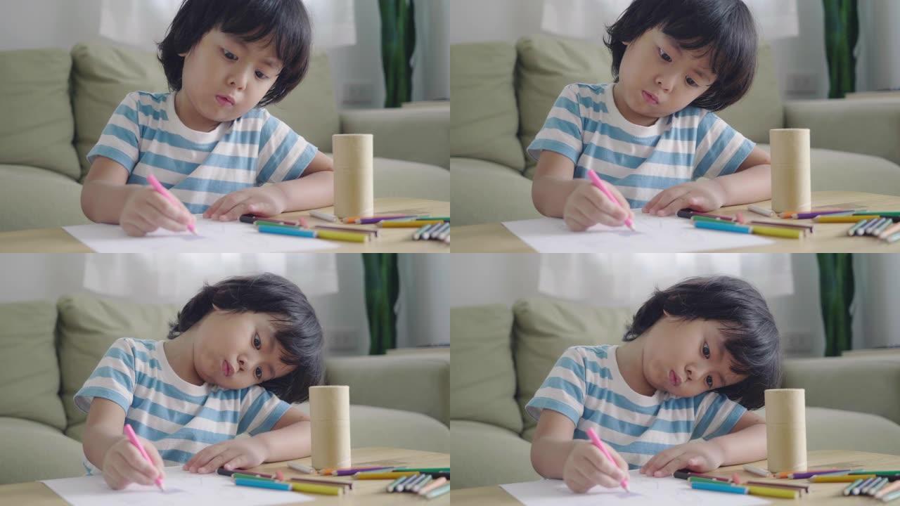 男孩在家里的桌子上画画
