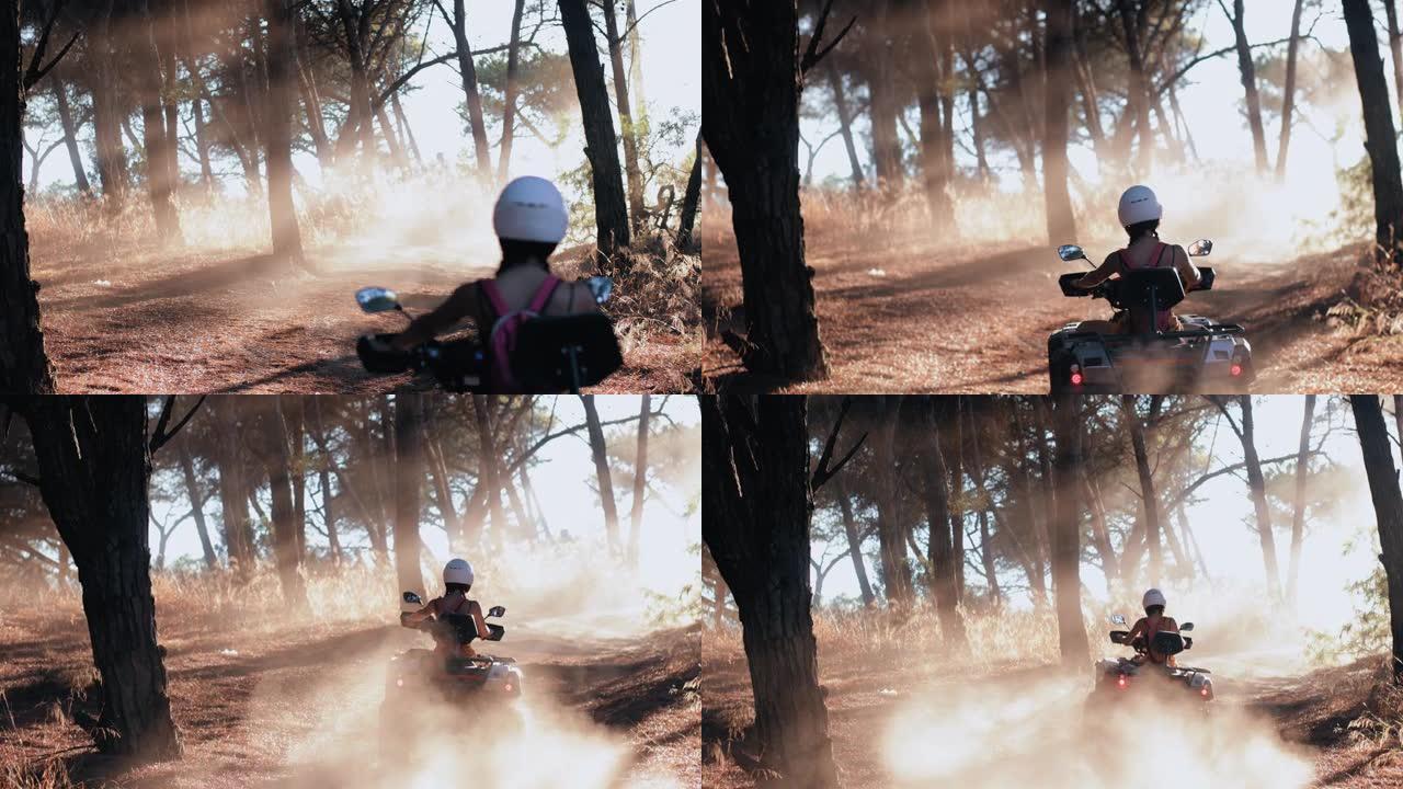 女人在森林里骑四轮摩托上山